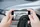 Person fotografiert Unfallschaden am Auto
