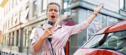 Eine Frau lädt ihr E-Auto