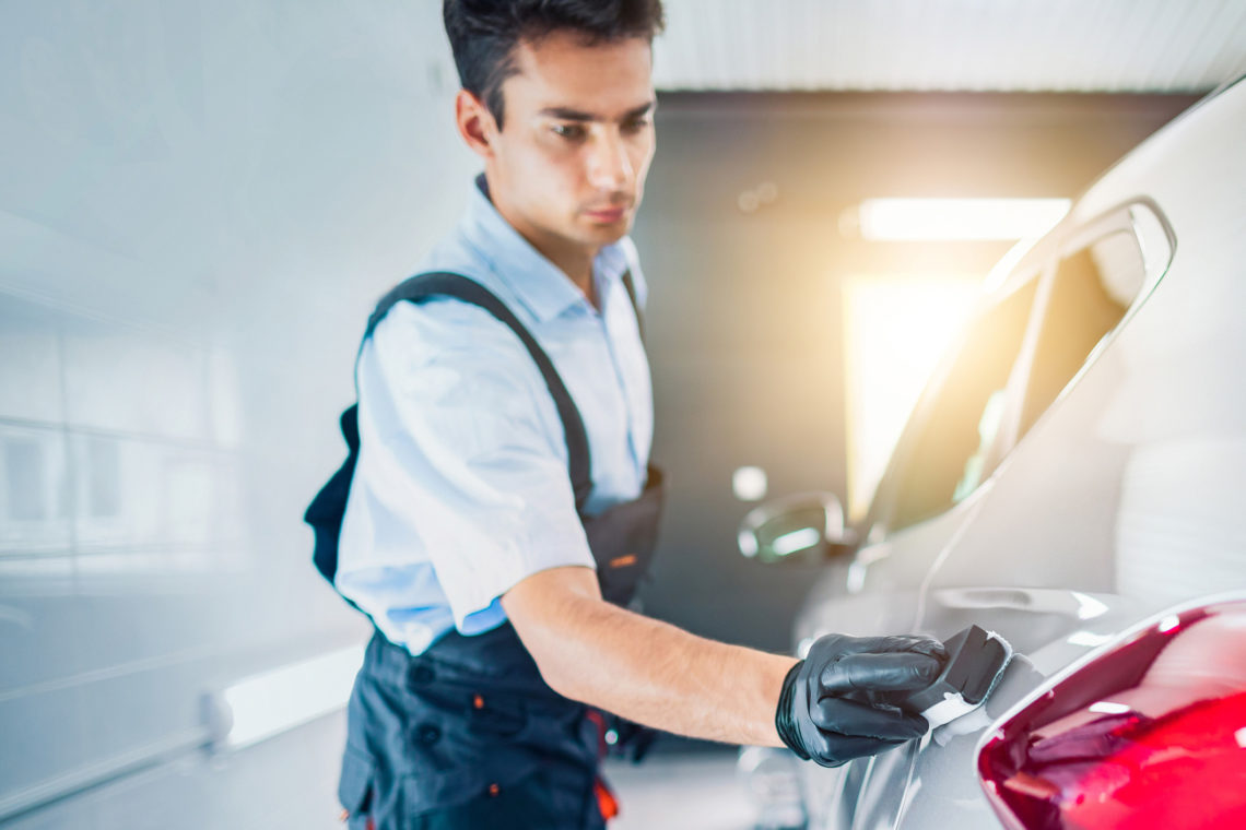 Ein Mechaniker poliert ein Auto